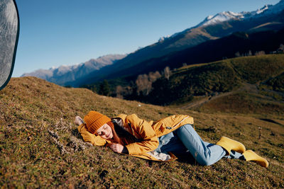 Low section of woman sitting on mountain