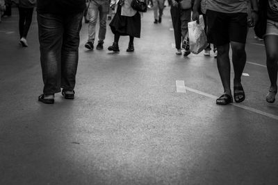 Low section of people walking on street