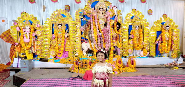 Portrait of smiling girl standing in temple