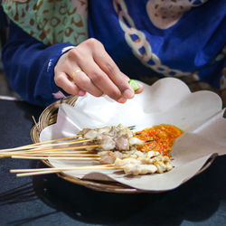 High angle view of woman preparing food on table