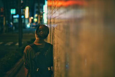 Women standing in city at night