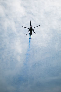 Low angle view of helicopter flying against sky