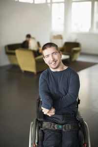 Portrait of happy businessman with cerebral palsy at office lobby