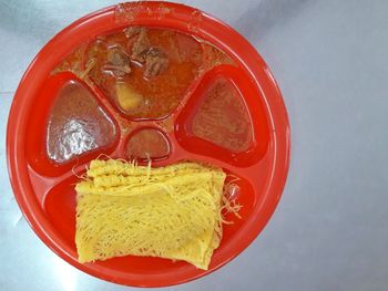 High angle view of red juice in glass on table