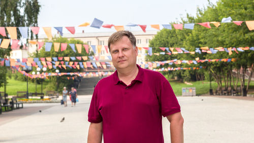 Blond man in the city square on a national holiday.