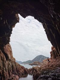 Rock formations by mountains against sky