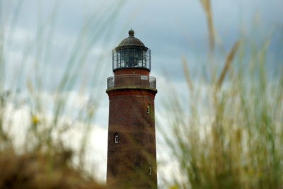 Close-up of  lighthouse on field against sky