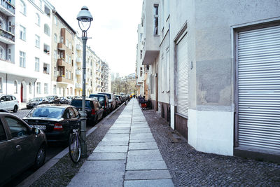 Residential buildings with cars parked on street