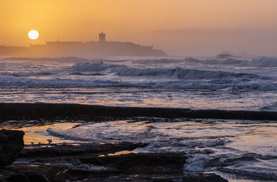 Scenic view of sea against sky during sunrise