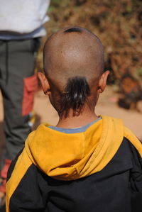 Rear view of bald boy