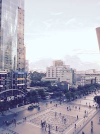 Panoramic view of people in city against sky