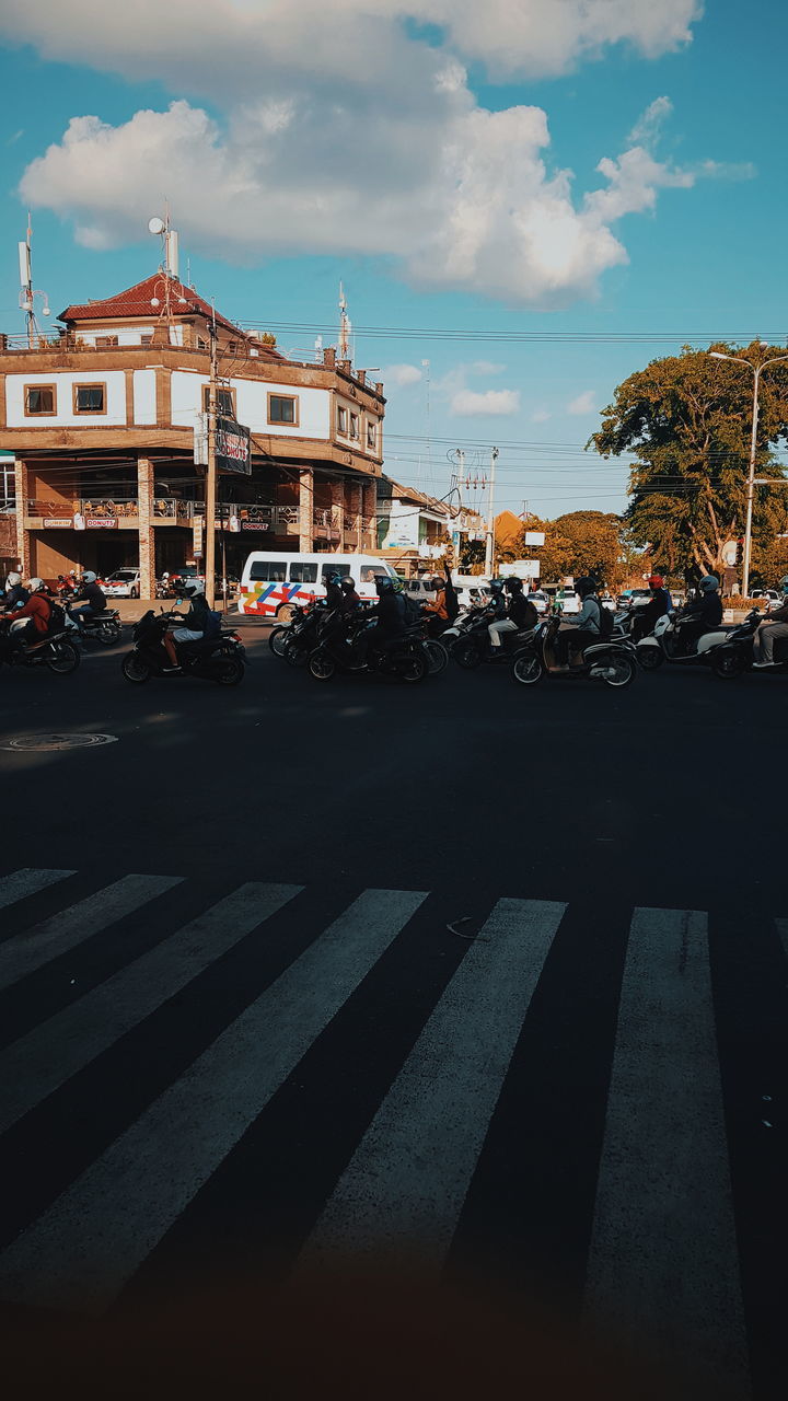 CARS ON ROAD AGAINST SKY