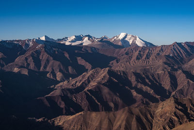 Scenic view of snowcapped mountains against clear sky