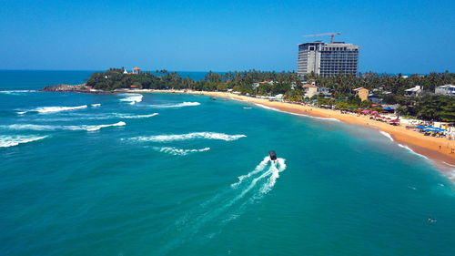 Scenic view of sea against clear blue sky