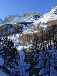 Scenic view of snowcapped mountains against clear sky