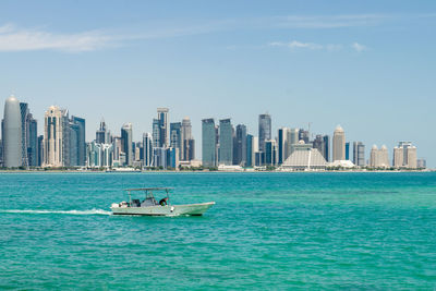 Scenic view of sea and buildings against sky