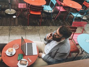 High angle view of man sitting on table