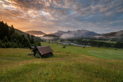 Scenic view of field against sky during sunset