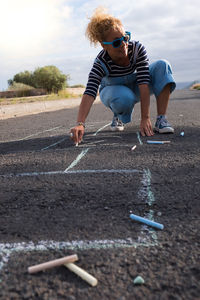 Man playing with umbrella on road