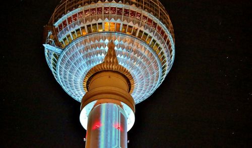 Low angle view of illuminated ferris wheel at night