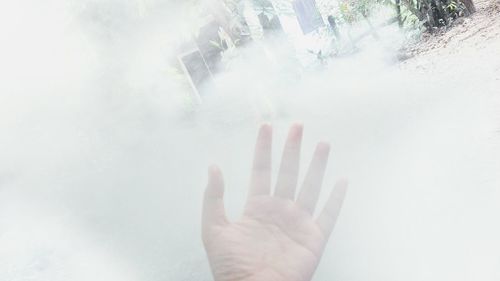 Close-up of hand in foggy weather