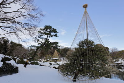 Cone structure covering tree on snow covered landscape