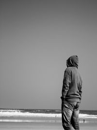 Rear view of man standing on beach