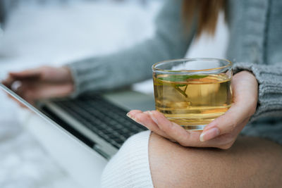 Close-up of hand holding drink