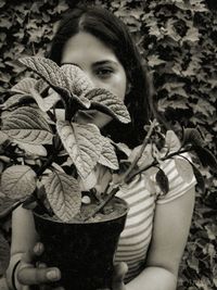 Portrait of girl holding leaves