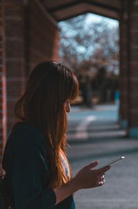 Woman using mobile phone outdoors