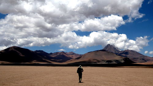 Full length of silhouette man with mountains in background