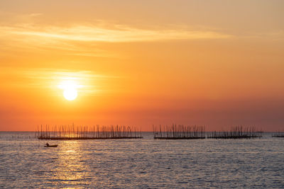 Scenic view of sea against orange sky