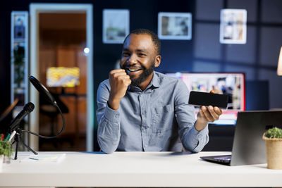 Young woman using mobile phone in office