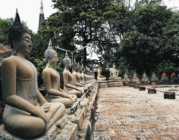 Side view of woman sitting on street
