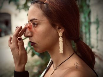 Portrait of young woman looking away outdoors