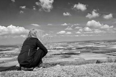 Woman looking at landscape against sky