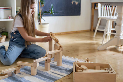 Woman sitting on table at home