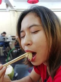 Portrait of woman eating girl