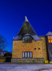 Low angle view of building against clear blue sky