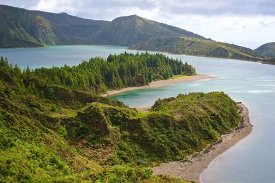 Scenic view of sea and mountains against sky