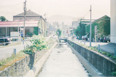 Road by buildings in city