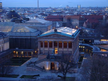 High angle view of buildings in city at dusk