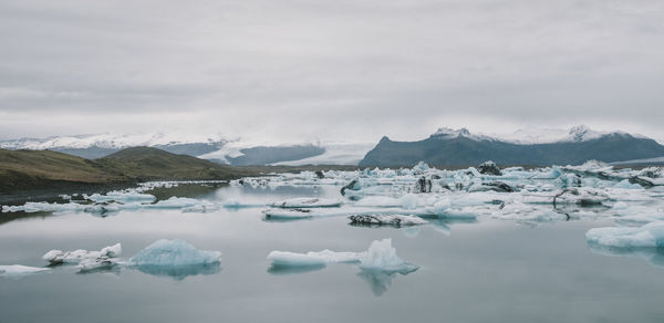 Scenic view of frozen lake against sky