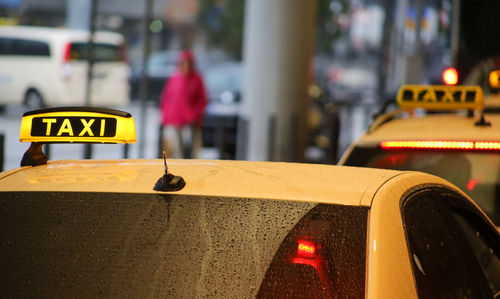 Close-up of yellow sign on car