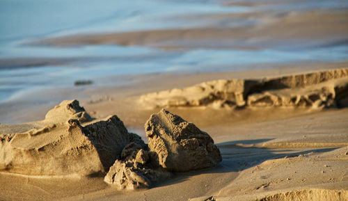 Close-up of sand on beach against sky