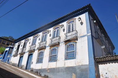 Low angle view of building against clear blue sky