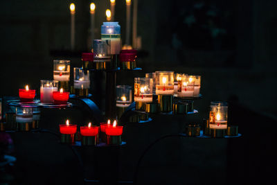 Illuminated tea light candles in temple