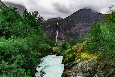 Scenic view of waterfall against sky