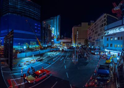 High angle view of city street and buildings at night