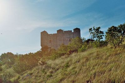 Old ruin building on field against sky
